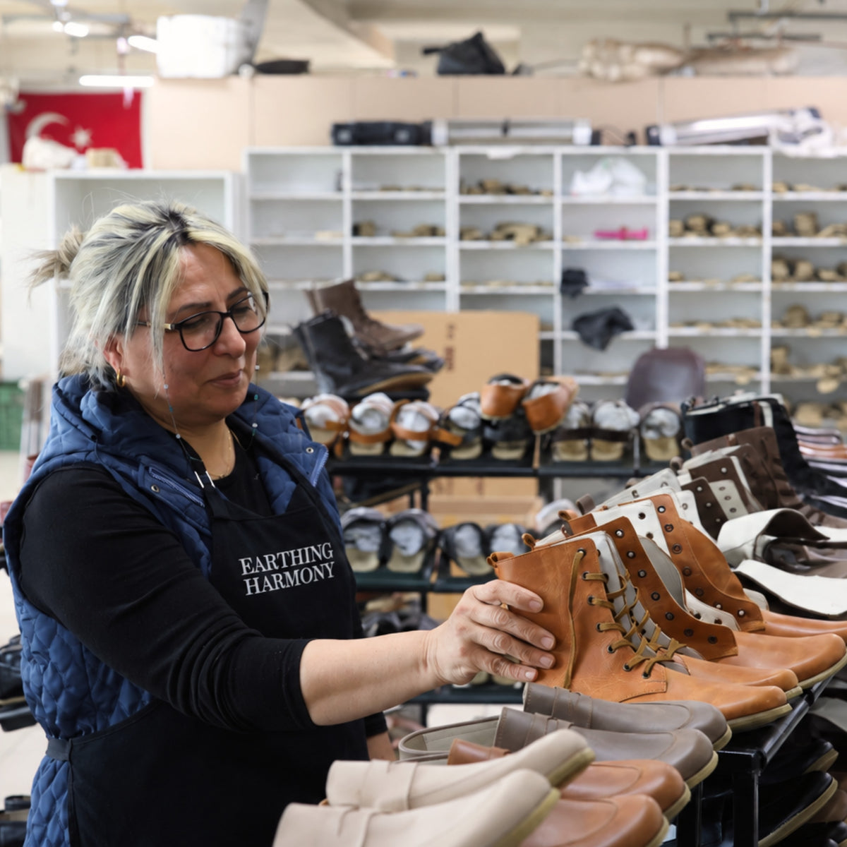 Artisan checking a finished pair of grounding shoes